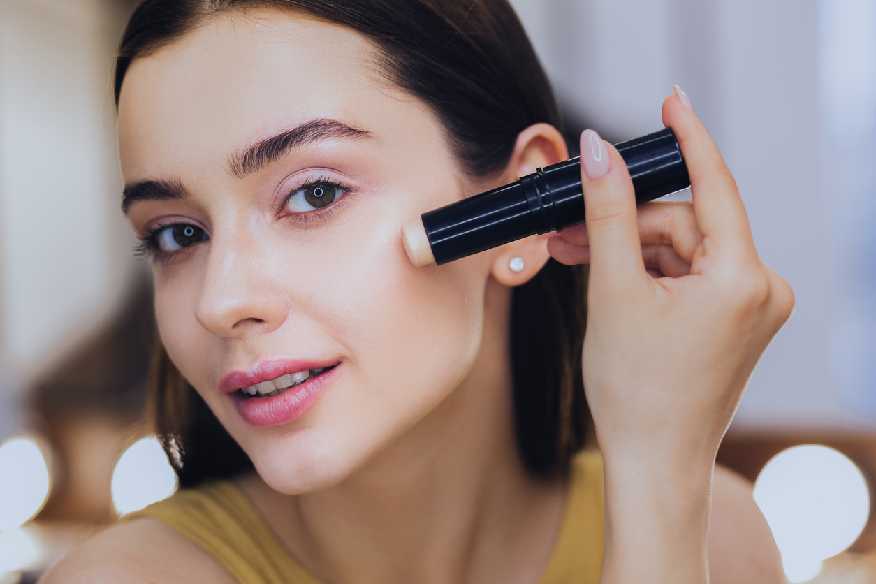 Woman using a foundation stick