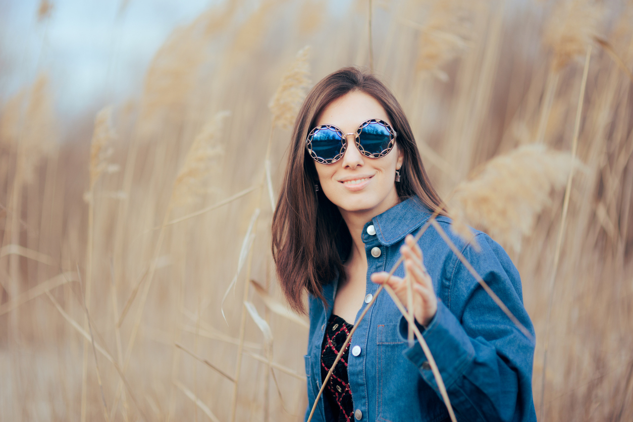 Pretty fashionista following style trends posing outdoors