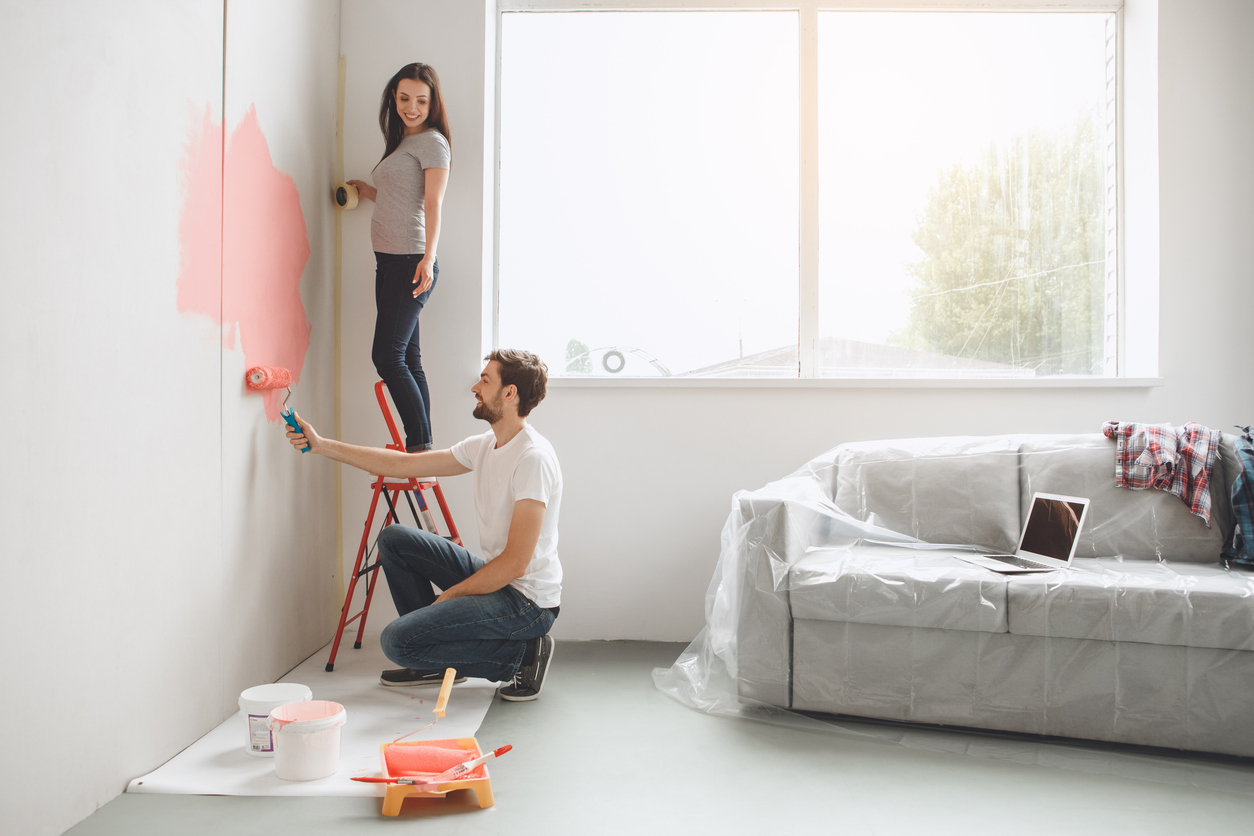 Young couple doing apartment painting together