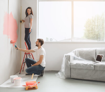 Young couple doing apartment painting together